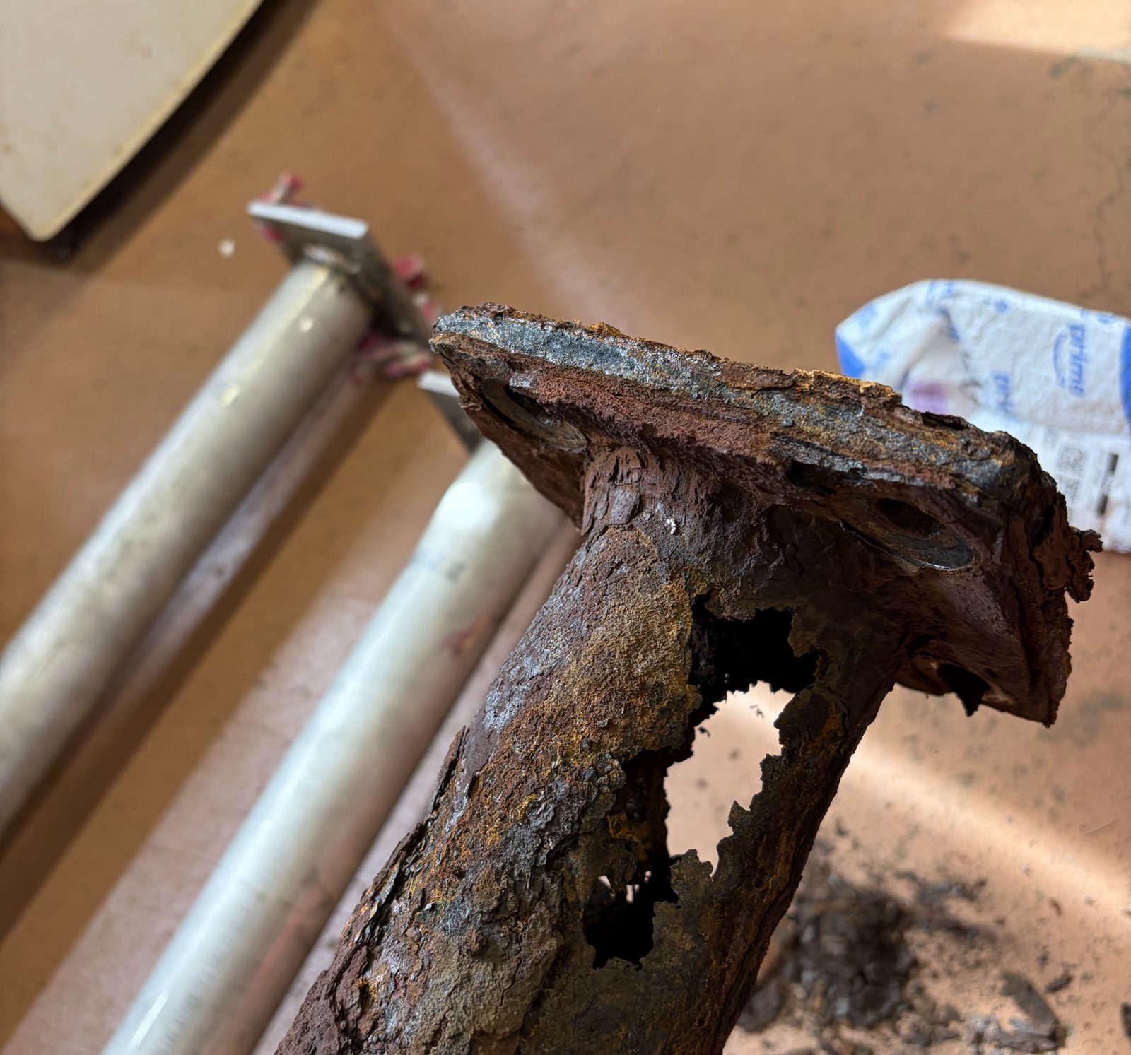 The original carbon steel post, rusted through at the base.
